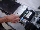 Step Two :: Lay the powerboard on a work platform upside down, and remove the four allen bolts that hold the electronics in place.